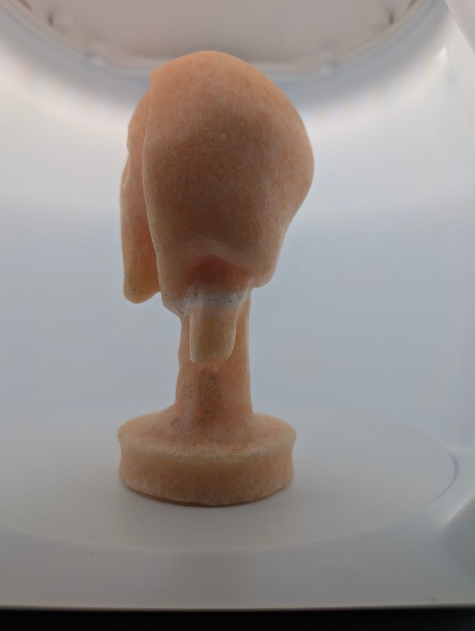 Side angle of Yellow Calcite “The Scream” crystal carving