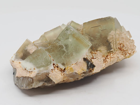 Golden yellow cubic fluorite cluster on feldspar matrix from Beijing China.