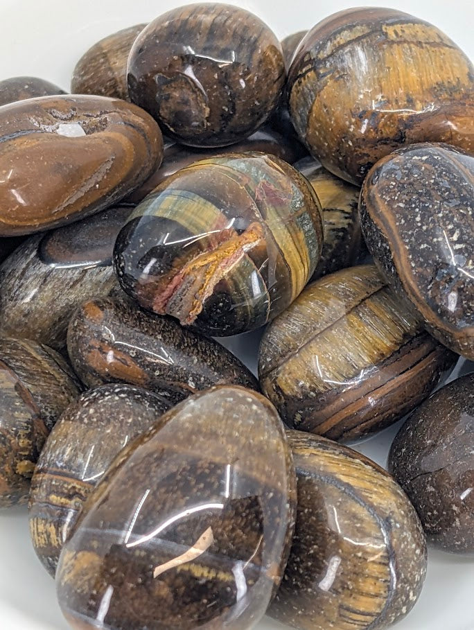 Close-up of polished Yellow Tiger Eye stones highlighting banding and chatoyancy