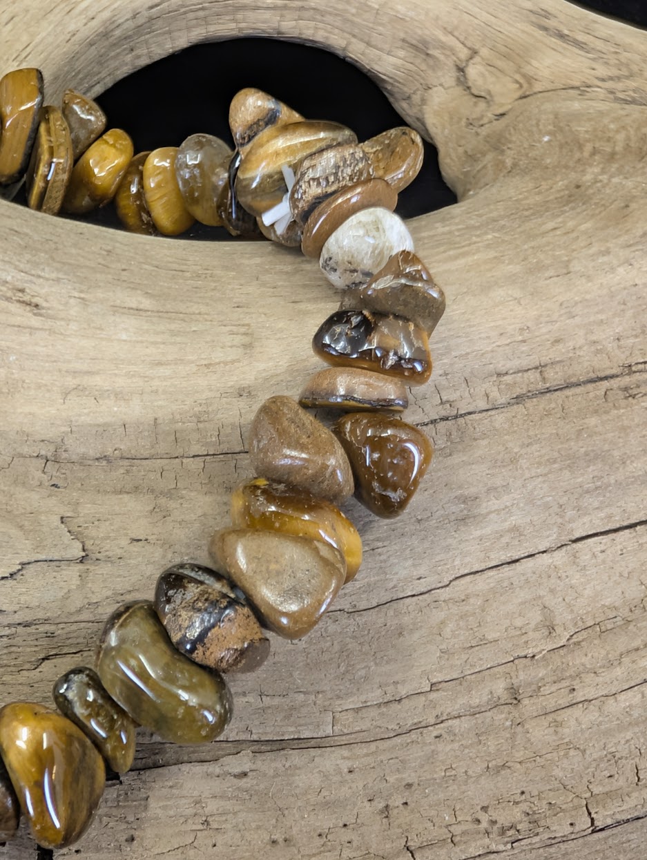 Macro view of Golden Tiger’s Eye chips showing the natural fibrous structure and reflective bands of light.