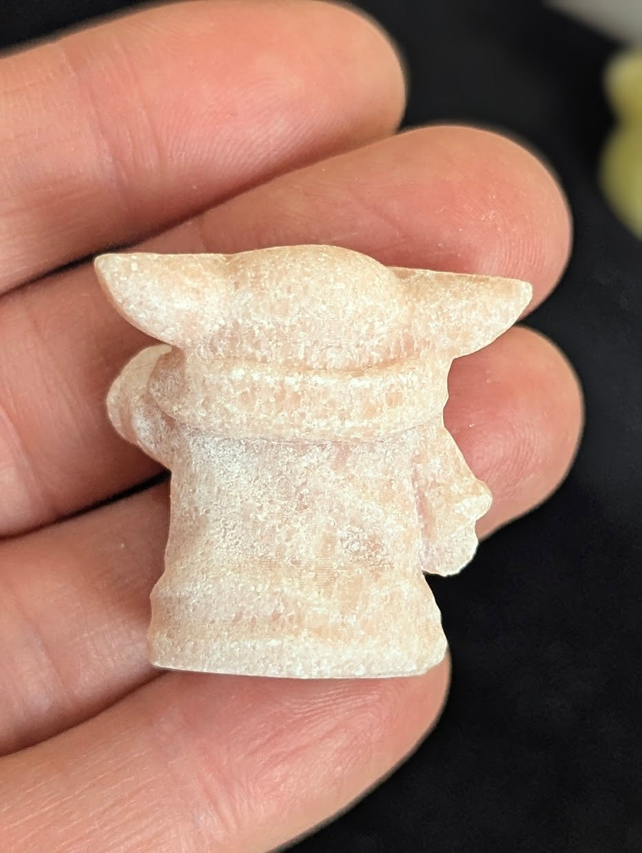 Rear view of a Pink Opal Yoda carving showing Jedi robes.