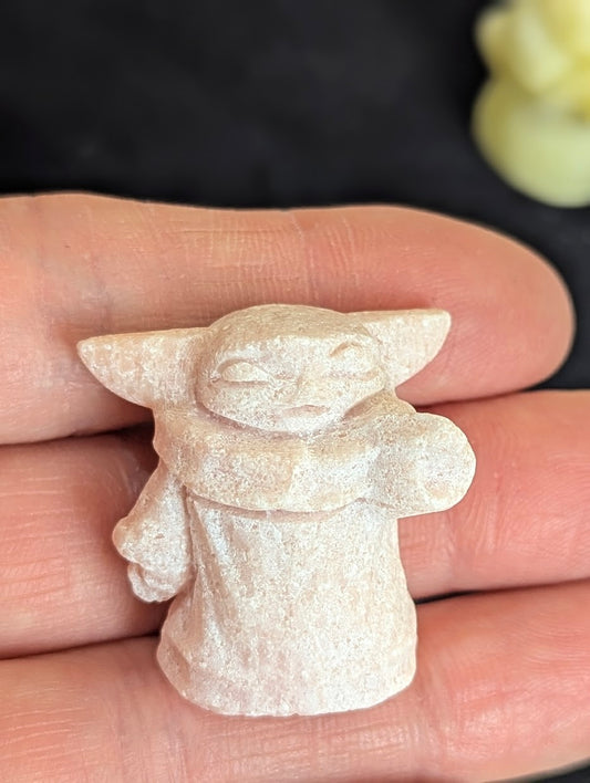 Front view of a 3cm Master Yoda carved from natural Pink Opal.