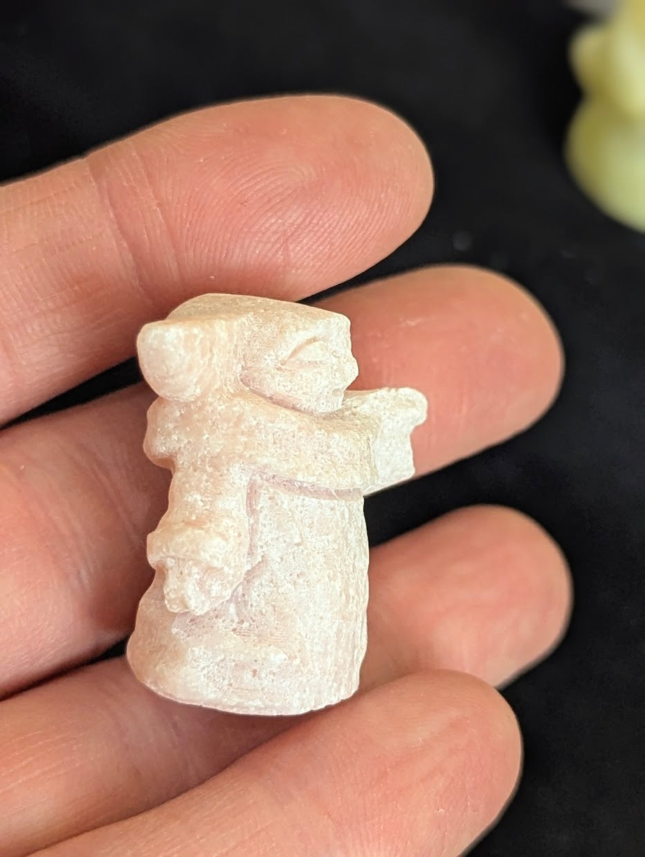 Side profile of a Pink Opal Yoda carving holding a cane