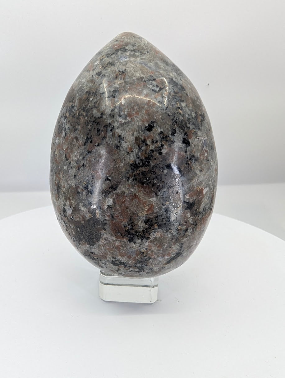 Polished yooperlite egg approximately 5 inches tall with dark igneous texture