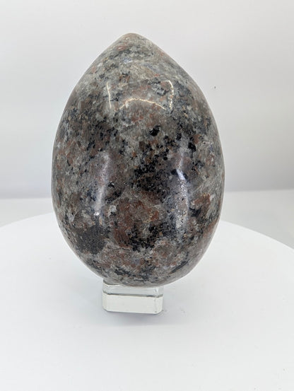 Polished yooperlite egg approximately 5 inches tall with dark igneous texture