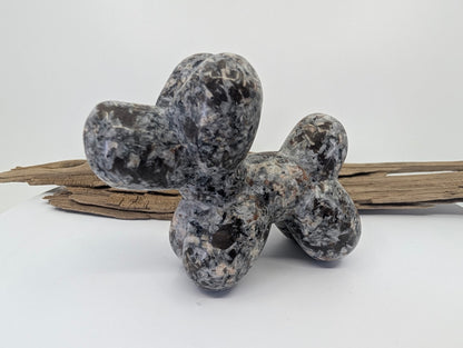 Syenite rich in Sodalite (Yooperlite) balloon dog specimen G with a mottled grey and black finish.